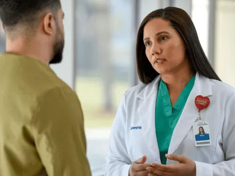 A Close Up of a Physician Speaking with a Patient 