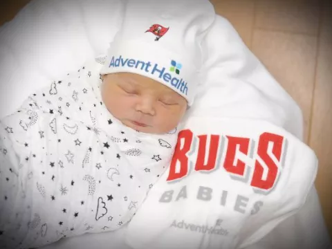 A 2021 newborn baby having clothes that show support for the Tampa Bay Buccaneers