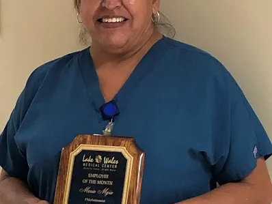 A Hispanic female holding an award.