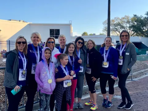 runners crossing finish line at AdventHealth Lady Track Shack 5k