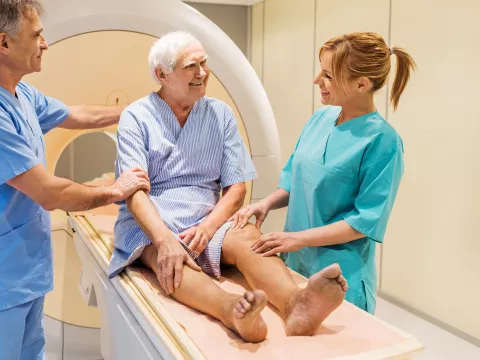 Friendly staff help a man prepare for an imaging test.