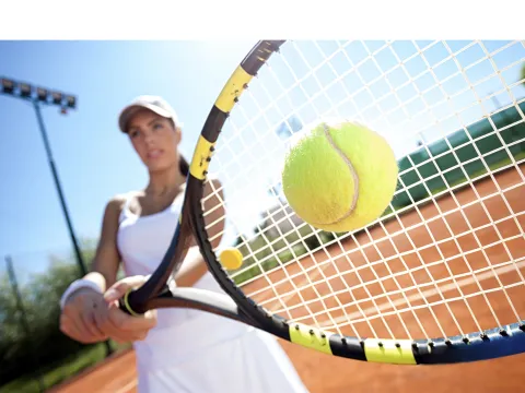 Woman Hitting a Tennis Ball