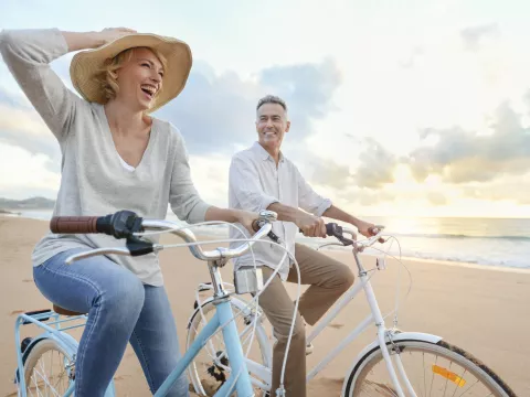 couple riding bikes on the beach