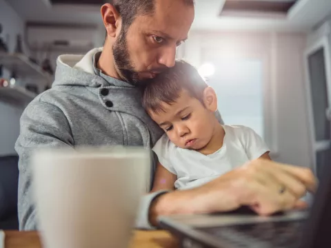 Father and son on the computer together.