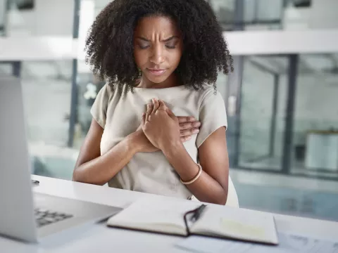 A young woman experiencing chest pain.