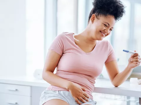 A woman seeing the happy results of her pregnancy test