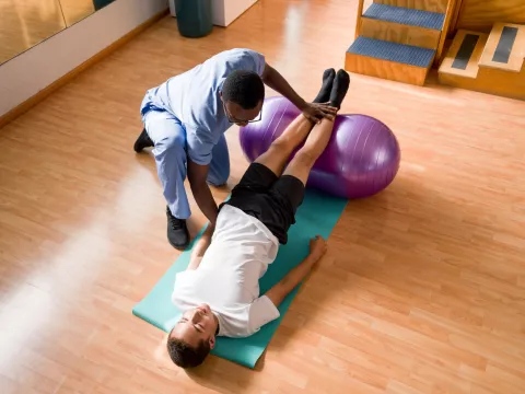 Physical Therapist working on stretching with patient