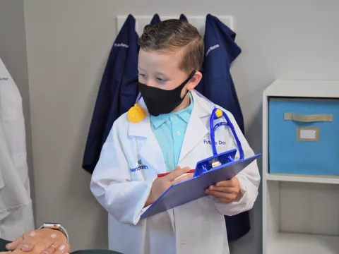 child pretending to be a doctor