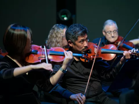 Grace Lai and Dr. Vincent Hsu with the AdventHealth employee orchestra.