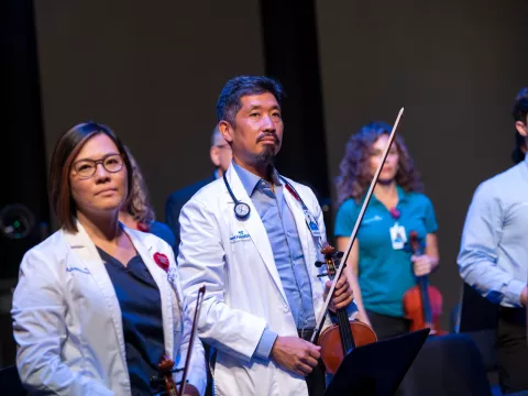 Grace Lai and Dr. Vincent Hsu with the AdventHealth employee orchestra.