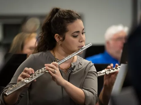Erica Kopp practices with the AdventHealth employee orchestra.