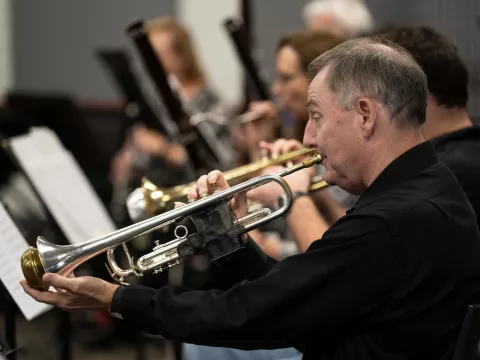 Ken Cutler practices with the AdventHealth employee orchestra.