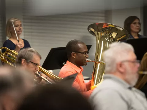 Paul Adeogun on the tuba practices with the AdventHealth employee orchestra.