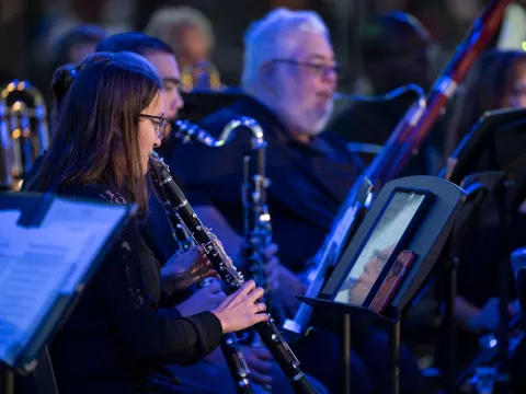 Amelia Lane performs with the AdventHealth employee orchestra at Disney Springs.