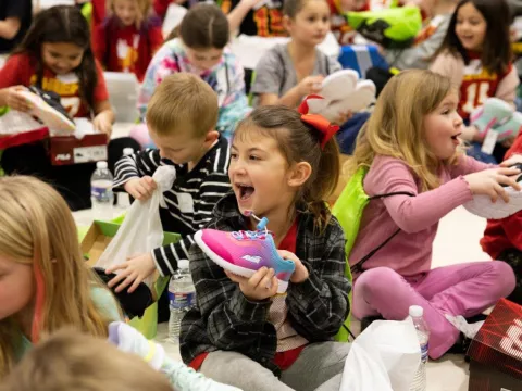 Little girls with a new pair of shoes.