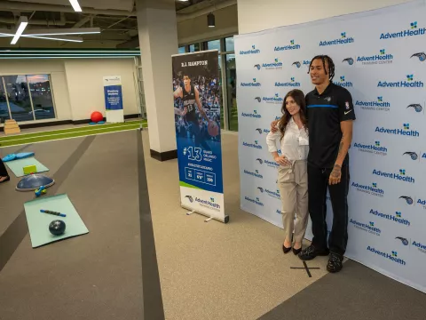 Guest poses with Orlando Magic player, R.J. Hampton, inside the Sports Medicine and Rehab facility within the AdventHealth Training Center 
