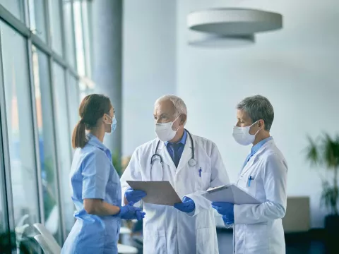 Two doctors and a nurse having a discussion