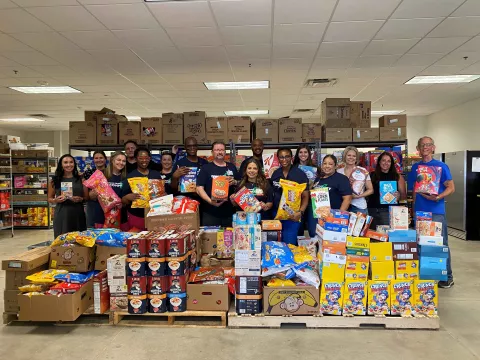 Texas Health Hospital Mansfield team and Mansfield Mission Center pose with 33,746 servings of cereal.