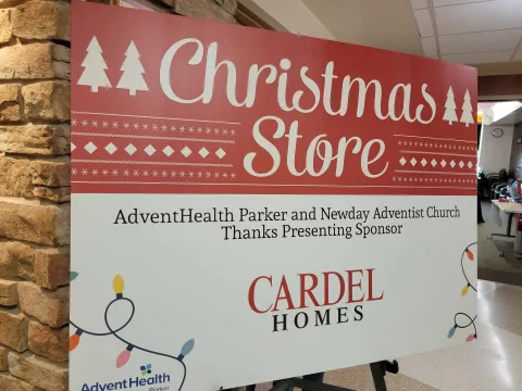 Sign welcoming families to the Christmas Store