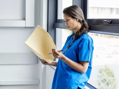 A doctor reads the results of a study.