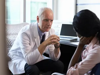 Patient contemplating with doctor about surgery