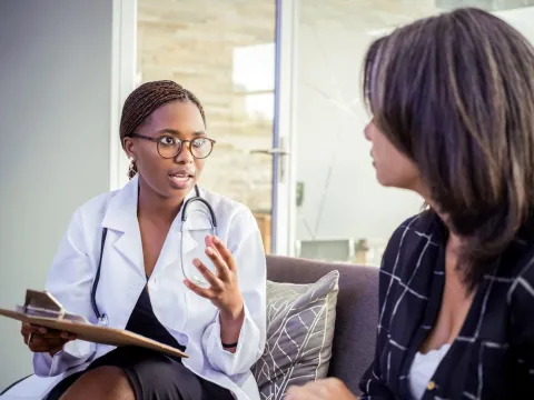 A woman talks with her doctor.