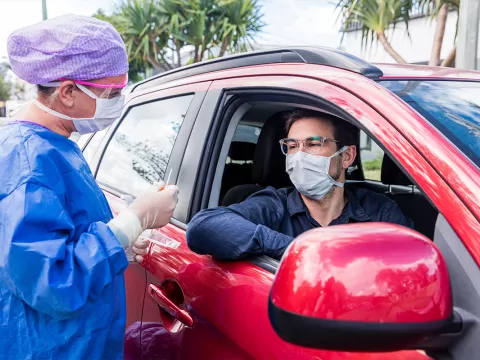 person receiving drive thru testing in a car