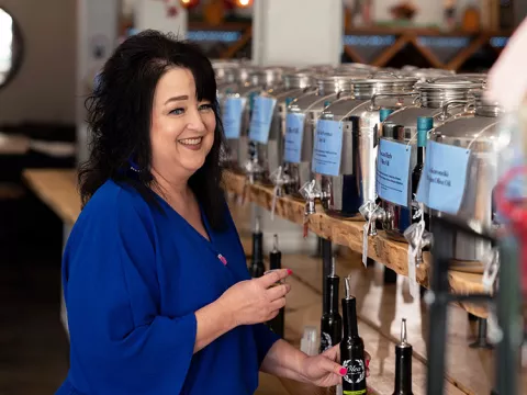 Sherri Hendrix pours olive oil for a taste test