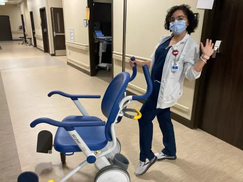 You can almost see the smile through her mask.