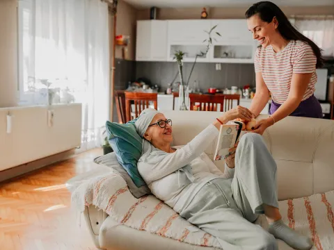 Mother and daughter relaxing together in the living room