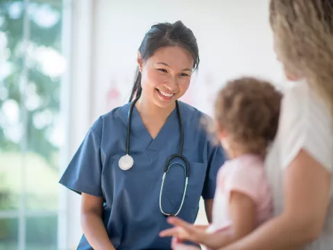 Nurse talking with mother and child.