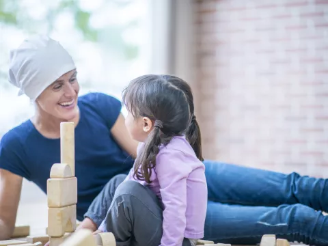 female brain cancer patient interacting with female child