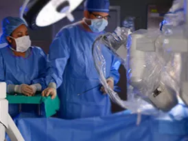 Surgeons conducting a robotic assisted surgery