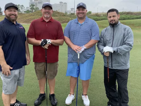Four happy players at the AdventHealth Golf Classic
