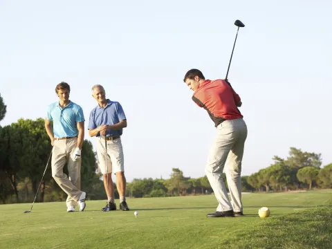 Three men golfing.