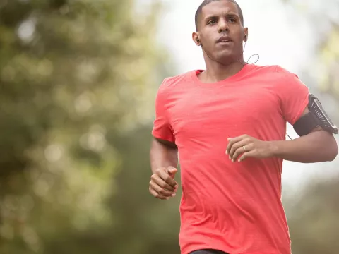 An adult running outdoors