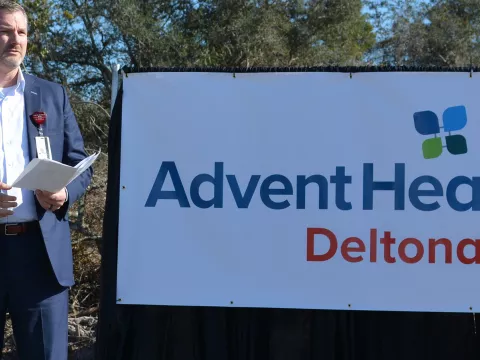 A speech being conducted outdoors for Deltona's emergency room building