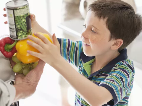 A boy discovering new types of vegetables. 