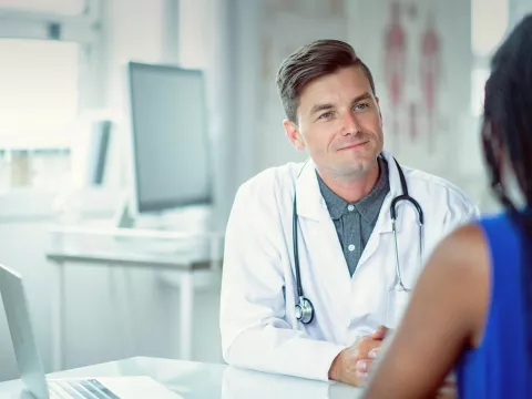 Doctor sitting at a table with a patient