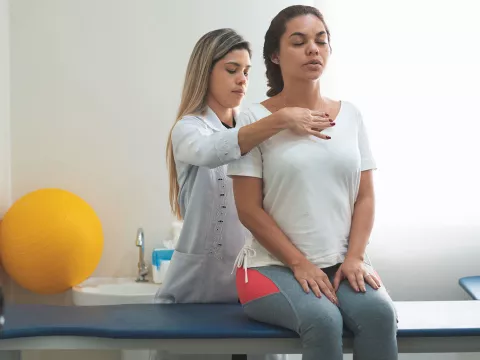 A doctor examines a patient's spine.