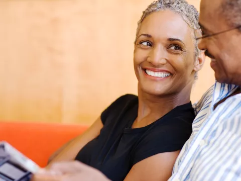 A couple sitting together on the couch.