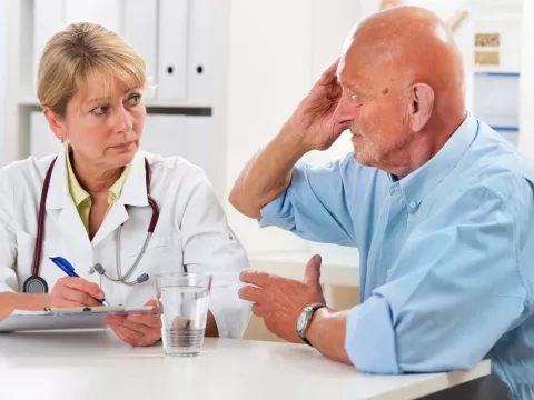 A man discusses his symptoms with his doctor.