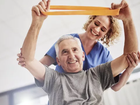 An older man receives physical therapy. 