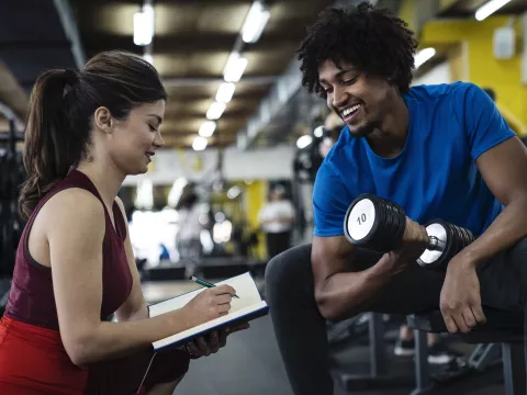 A man exercising with a personal trainer.