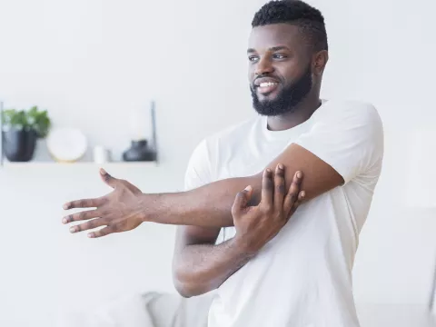 A man stretching at home.