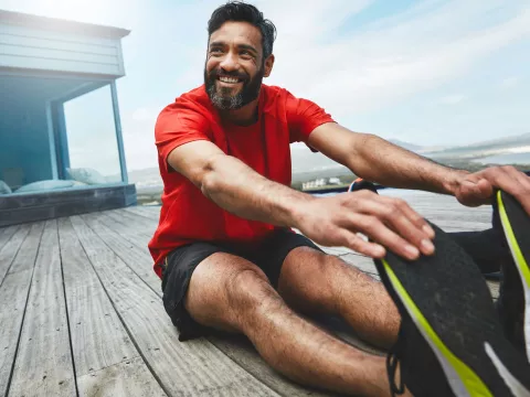 A man stretches his lower back after a workout.