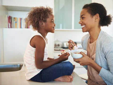 A mom and child eating a healthy breakfast together.