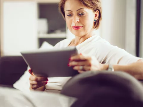 Older Female Reading on Couch