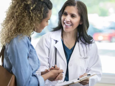 A woman discusses study results with her doctor. 