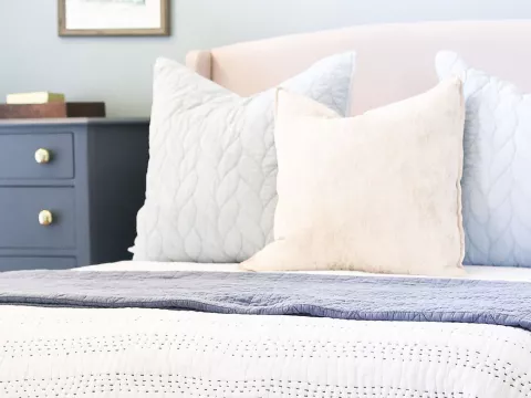 Tidy bedroom with a bed and dresser.